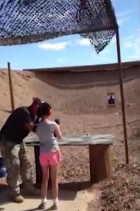 The last seconds of shooting instructor Charles Vacca's life, as he stands next to the 9-year-old girl.