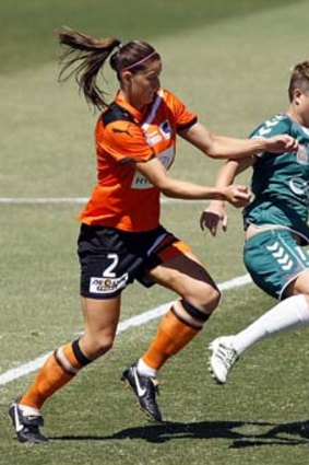 Under attack: Brisbane Roar's Laura Alleway (left) battles with Michelle Heyman of Canberra United.