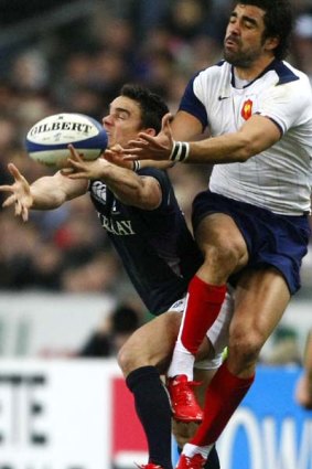 Moray Low of Scotland and Yoann Huget of France challenge for the high ball.