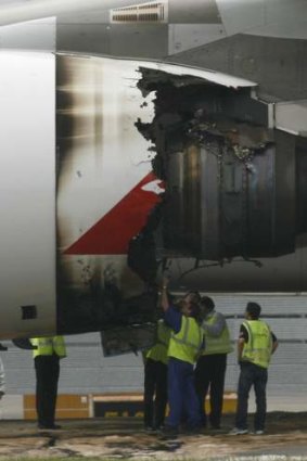 Technicians inspect the damaged engine on QF32 in 2010.