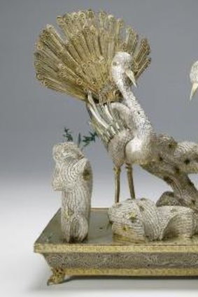 A Chinese table decoration in the form of a pair of birds in silver and enamel.