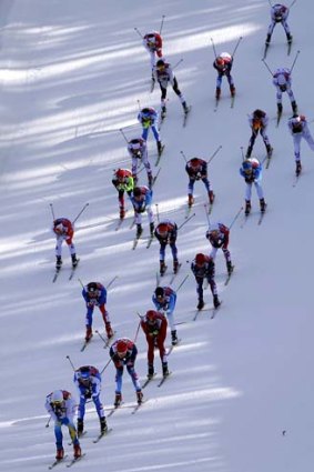 Athletes compete in the men's 50km mass start free in Sochi on Sunday.