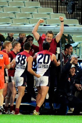 Oh yeah: Mark Neeld and his players celebrate.