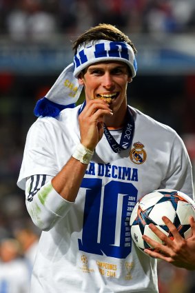 Bale celebrates last year's Champions League final win in Lisbon.