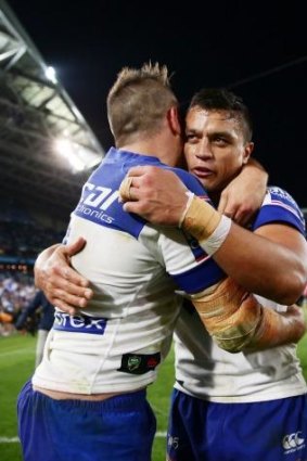 Josh Reynolds hugs Sam Perrett after the victory over the Panthers.