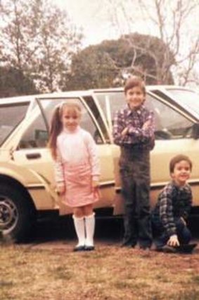 Vincent Fantauzzo (standing), aged 9, with his brother and sister in front of the family's Ford Falcon.