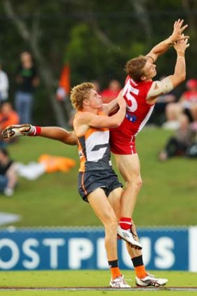 Kieren Jack of the Swans is challenged by  Adam Kennedy of the Giants.