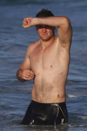 James Horwill shields his eyes from the sun during a recovery session at Coogee beach in Sydney on Monday.