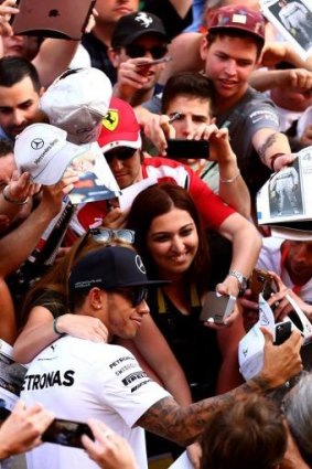 Mobbed: Lewis Hamilton takes a selfie with his fans at Spain’s Circuit de Catalunya.
