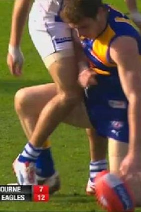 Low blow: West Coast's Luke Shuey denies striking North's Lindsay Thomas in the groin.