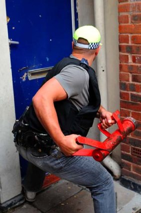 Police raid a building in London.