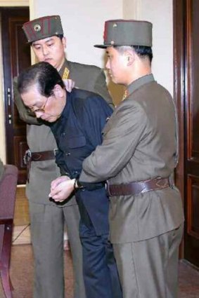 Final humiliation: Jang Song Thaek, with his hands tied with a rope, is dragged into court before he was executed.