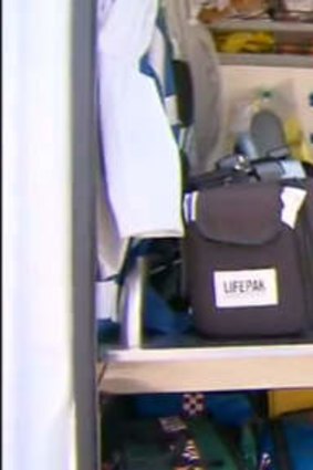 The young woman sits in an ambulance after being rescued.