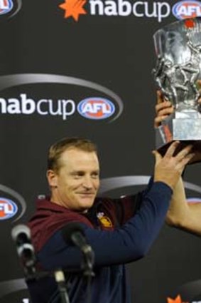 One for history: Brisbane's coach Michael Voss and captain Jonathan Brown hold the 2013 NAB cup at Etihad Stadium in March.