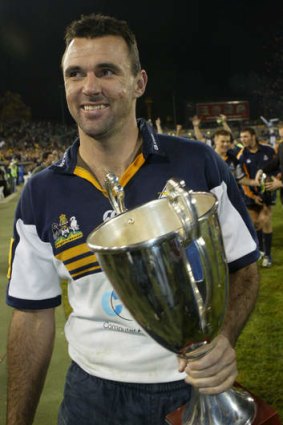 Brumbies great Joe Roff with the Super 12 trophy in 2004.