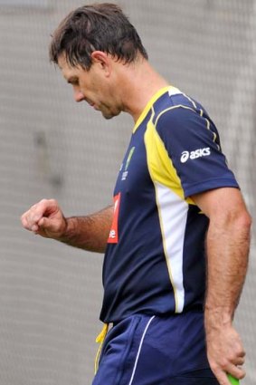 Ricky Ponting inspects his hand after being struck on the glove by James Pattinson.