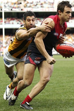 Big-time tackler: Paul Puopolo gets a grip on Demon Adam Maric in their round 18 clash.
