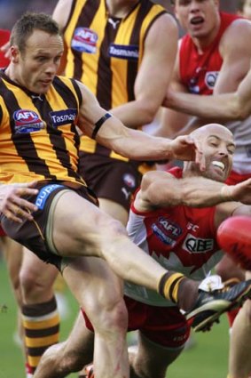 Sydney's co-captain Jarrad McVeigh attempts to smother the kick from Brad Sewell in the grand final.