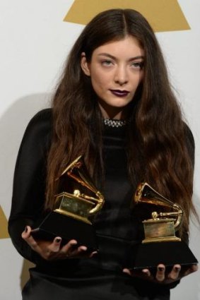 Lorde poses with her Grammy Awards.