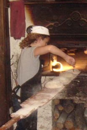 Tessie Vanderwert gets up close and personal with the wood-fired oven at Trentham's Red Beard Bakery.
