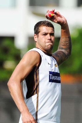 Wrong sport: Lance Franklin tests out his cricket skills at Hawthorn's first full training session in preparation  for 2012.