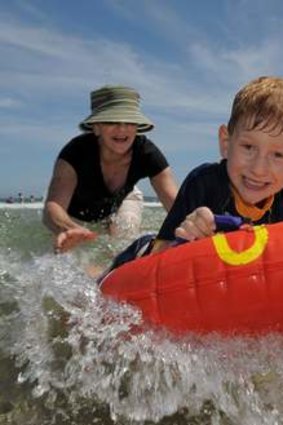 Enjoying the surf at South Broulee are Sharon Schaefer of Broulee and her grandson, 6 year old Luke Bombanato of Summer Hill.