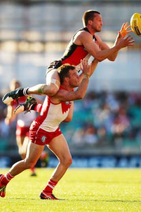 Over the top: St Kilda's Jarryn Geary marks over Sydney's Ben McGlynn.