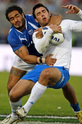 Italy's Australian-born fullback Luke McLean is tackled high b Henry Fa'Fili of Samoa.
