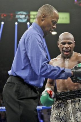 Floyd Mayweather jnr speaks to referee Kenny Bayless, left, after he claimed that Marcos Maidana bit his hand.