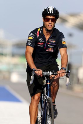 Life in the slow lane: Australian Daniel Ricciardo rides his bicycle in pit lane at the Sepang Circuit in Kuala Lumpur