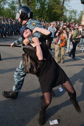 A Russian police officer detains protester Alexandra Dukhanina during an opposition rally in Moscow in 2012.