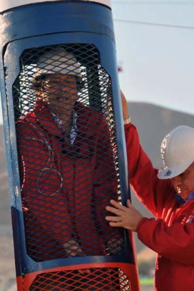 Chilean Minister of Mining Laurence Golborne (left), checks the capsule designed by the Chilean Army's Shipyards (ASMAR), through which the 33 miners trapped in San Jose mine will be rescued.