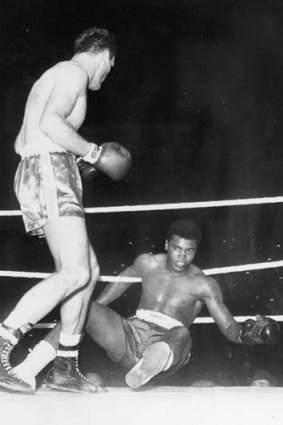 Rare sight ... Henry Cooper sends Ali to the canvas in 1963 but lost by TKO in the next round.