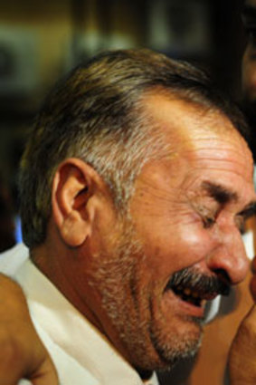 Relatives of a victim of the crash mourn at Karachi airport.