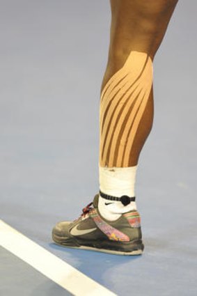 Serena Williams with strapping on her left calf during her match against Tamira Paszek on Rod Laver Arena.