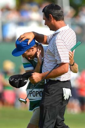 Good day out: Daniel Popovic celebrates his PGA Championship win on Sunday with his caddie.