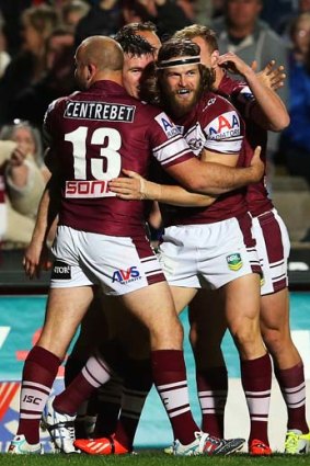 David Williams of the Sea Eagles celebrates with team mates after scoring his first try.