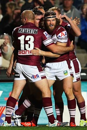 David Williams of the Sea Eagles celebrates with team mates after scoring his first try.