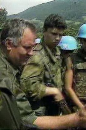 Mladic pats eight-year-old Izudin Alic on the head in 1995.