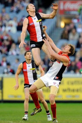 Up, up and away: St Kilda's Ben McEvoy soars over Demon Jake Spencer at the MCG on Saturday.
