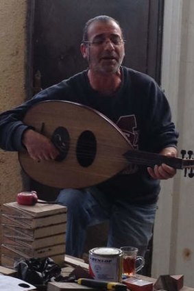 A worker plays the oud outside Madaba.