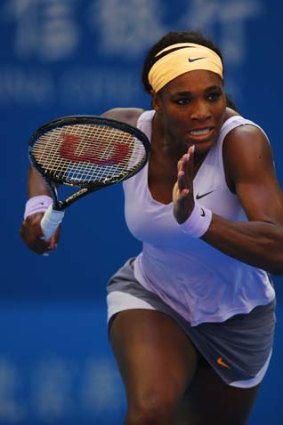 Serena Williams makes a charge for the ball during her match against Francesca Schiavone of Italy at the China Open on Tuesday.