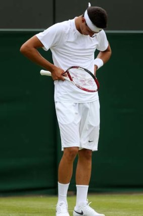 When the going gets tough: Bernard Tomic during his first-round loss at Wimbledon.