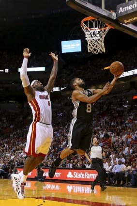 Court of dreams ... Patty Mills goes for a lay-up with Miami star LeBron James in pursuit.