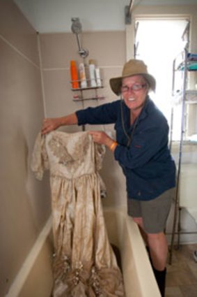 Taking heart ... Linda Godley washes her wedding dress.