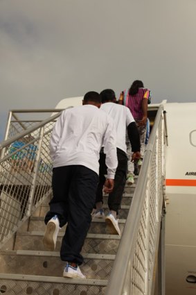 Asylum seekers board a plane from Christmas Island back to Sri Lanka.