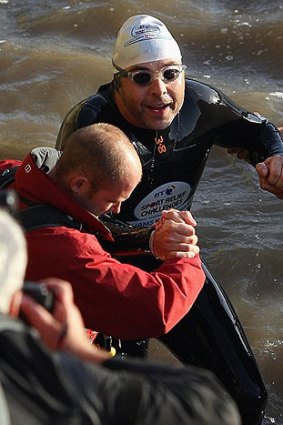 Walliams is helped from the water at the conclusion of his epic swim.