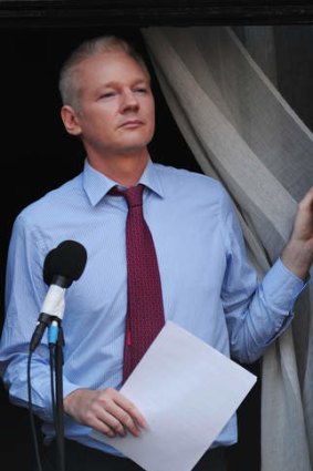 Julian Assange looks out from the balcony of the Ecuadorian Embassy.