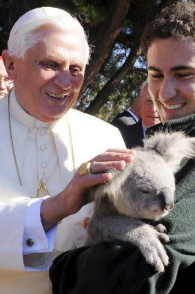 Pope Benedict pats a koala held by an animal keeper at  the Kenthurst Study Centre on Sydney's outskirts yesterday, where the Pope is resting before he officiates at World Youth Day celebrations.