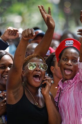 Protesters calling for the impeachment of President Robert Mugabe demonstrate outside the parliament building. 